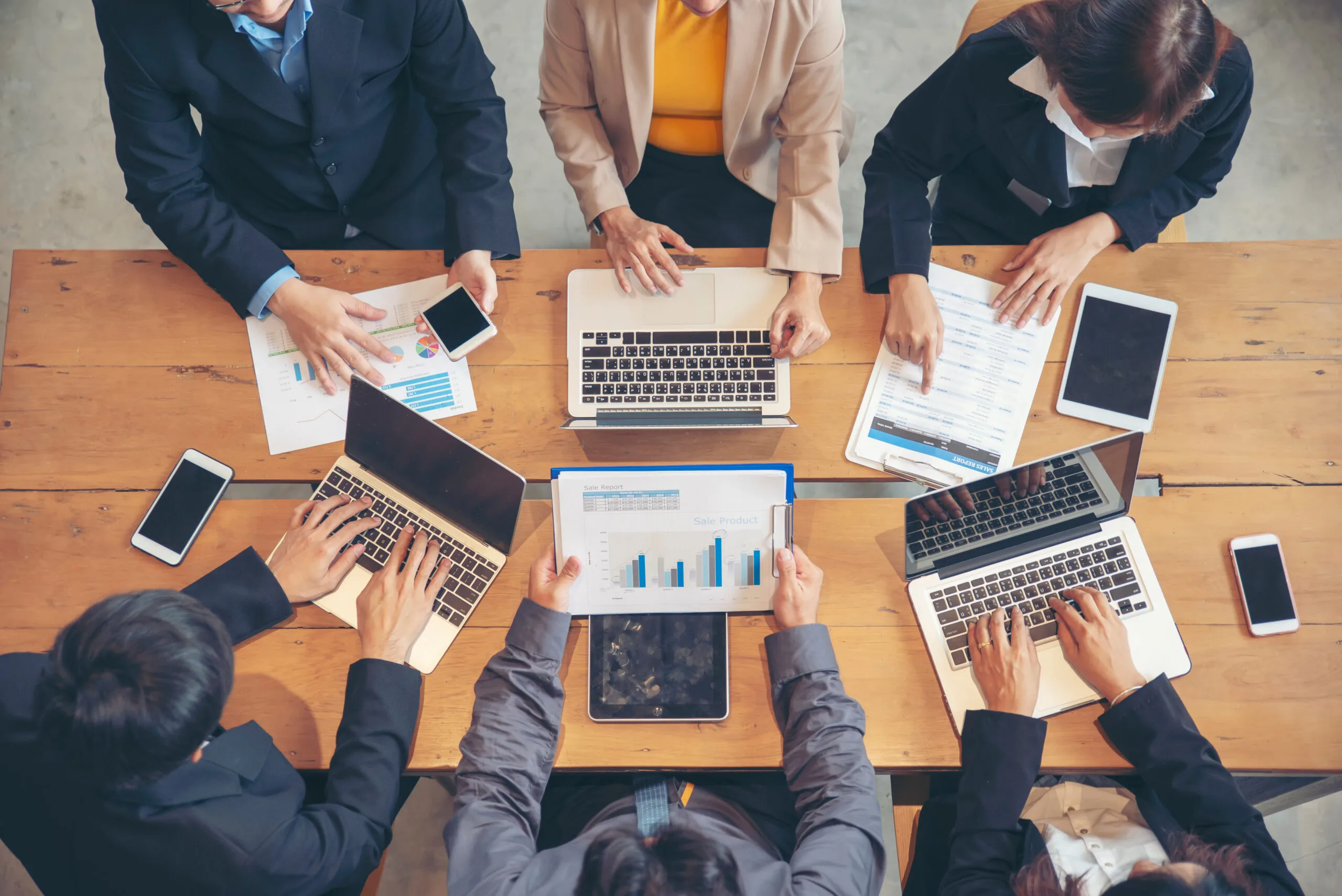 Group of People working together with laptop on wooden office de